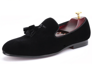 Midnight black velvet-look, tasselled loafer with red, quilted lining.
