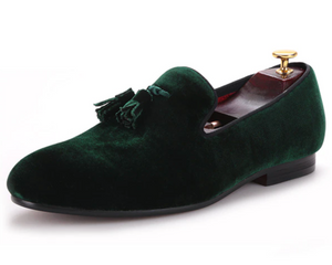 Forest-green velvet-look tasselled loafers with red quilted lining.