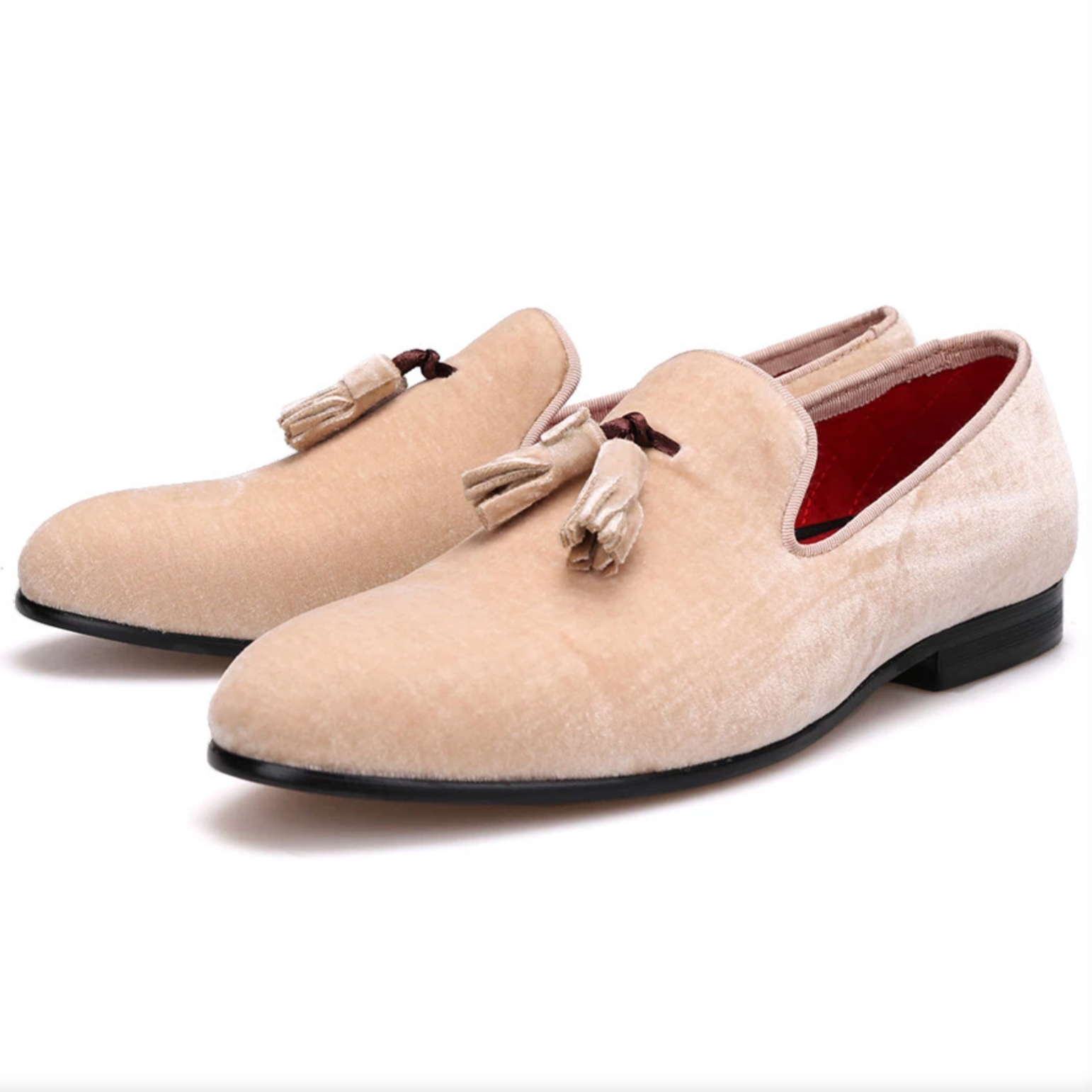 Ivory-white tasselled loafers with a plush red quilted lining. 